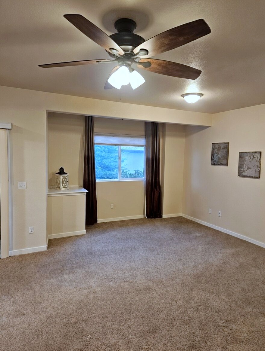 Ceiling fan with light kit and ceiling light in a living room