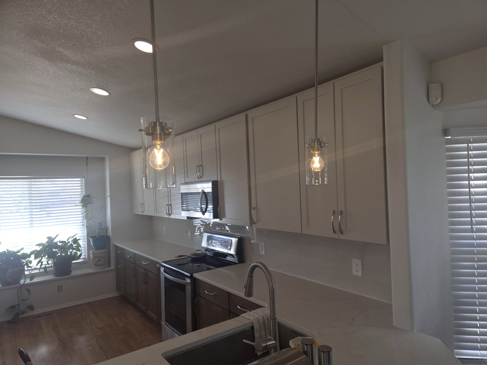 Kitchen pendant lights and recessed can lighting over new cabinets