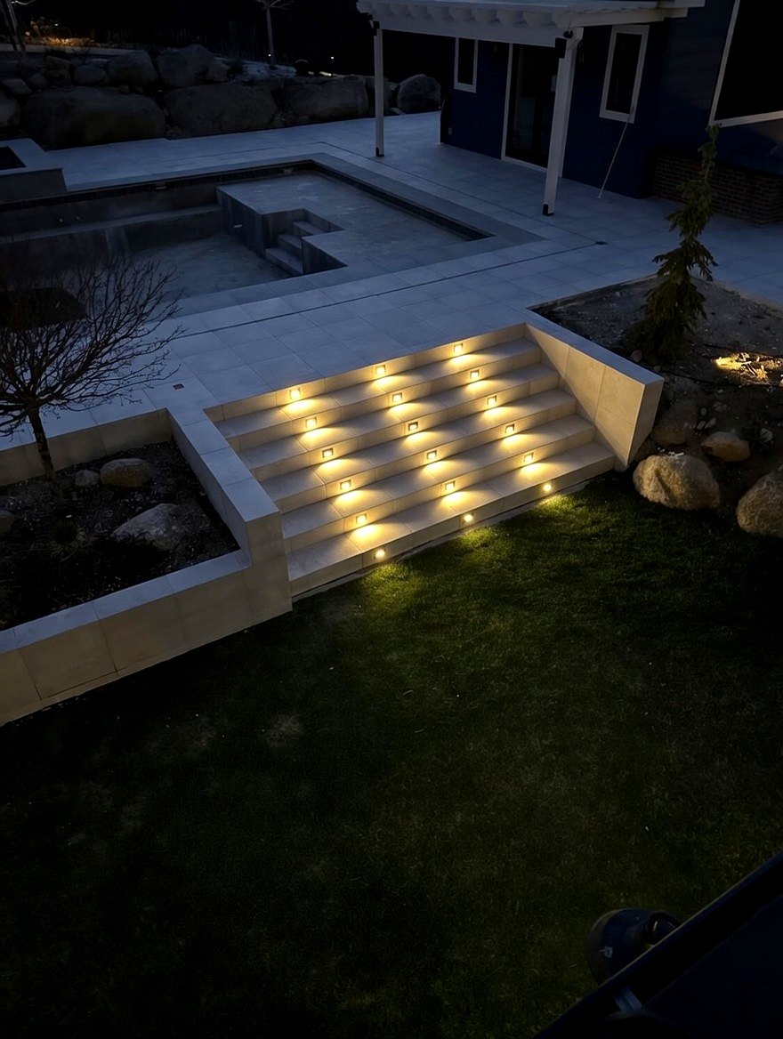 Recessed LED step lights on patio stairs at night